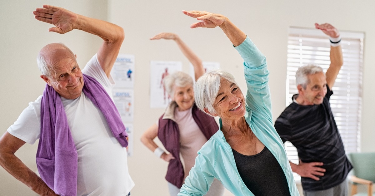 Senior people stretching at gym