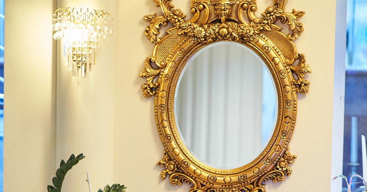 Old carved round mirror with gilding