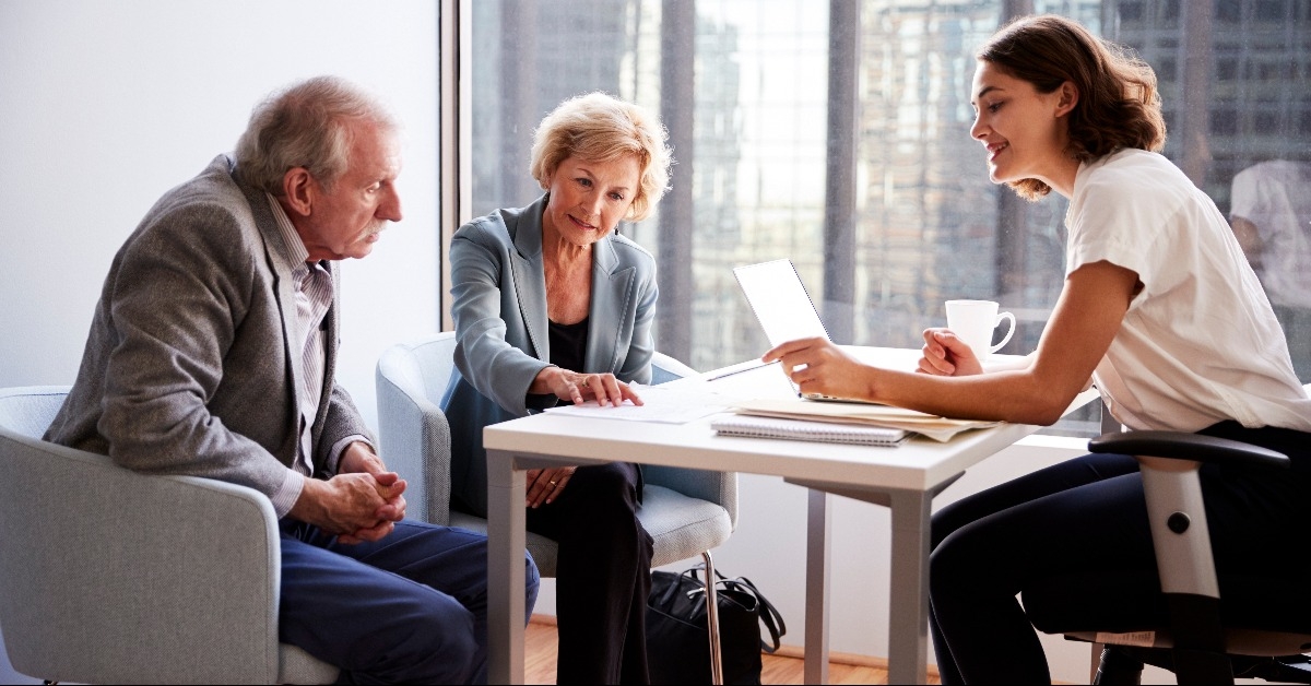 senior couple meeting with female financial advisor
