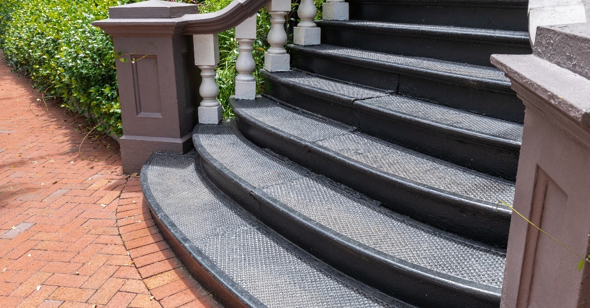 staircase with black cast iron treads