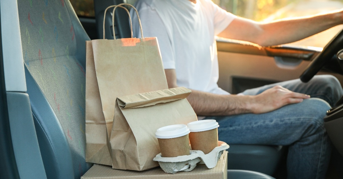 Blank box coffee cups paper packages and courier in car