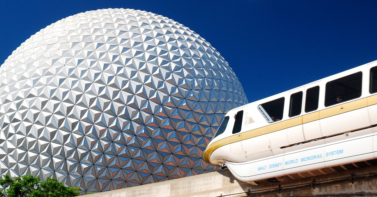 A monorail passes in front of Spaceship earth
