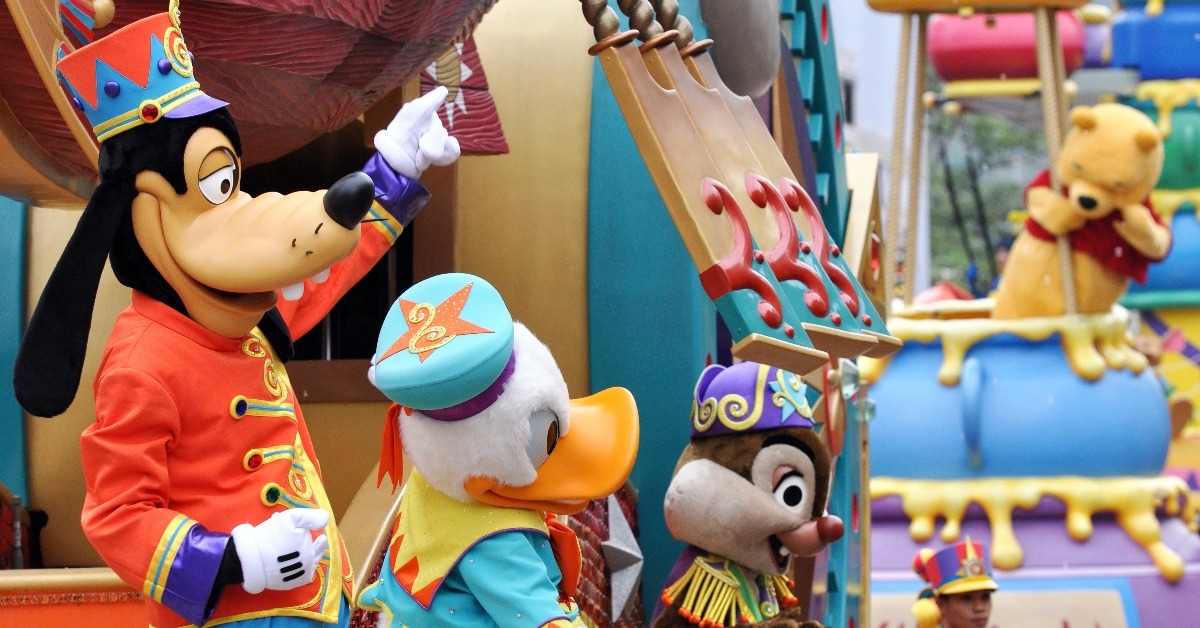 Parade in Disneyland with famous cartoon characters in Hong Kong