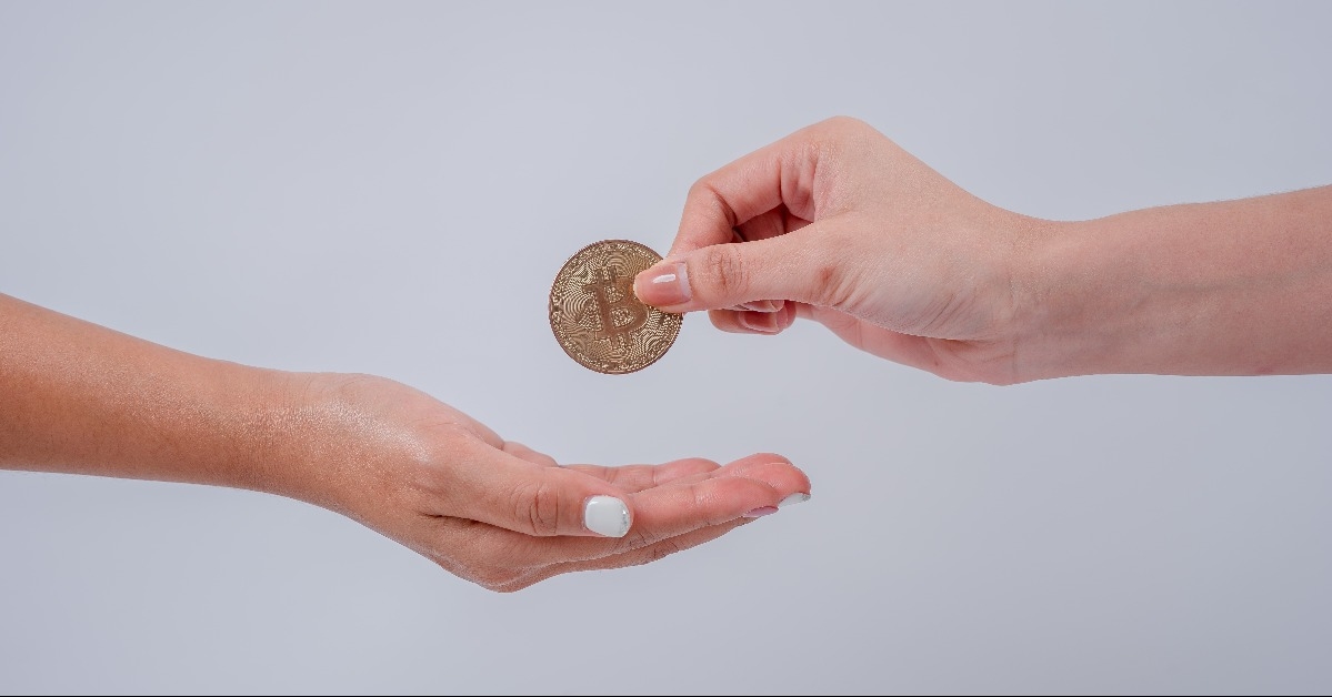 Businessman gives gold bitcoins to another woman