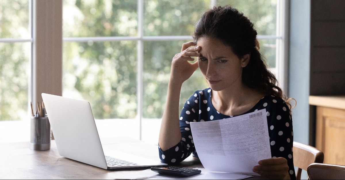 Concern housewife checking utility bill