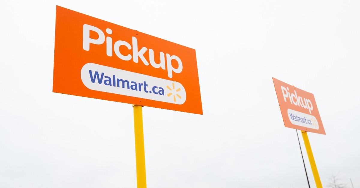 Grocery pickup signs in the parking lot of a Walmart Canada supercentre