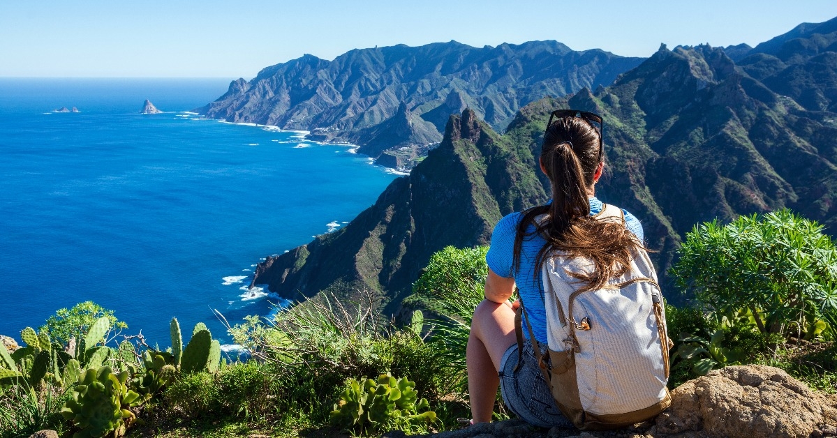 Woman hiker watching beautiful costal scenery
