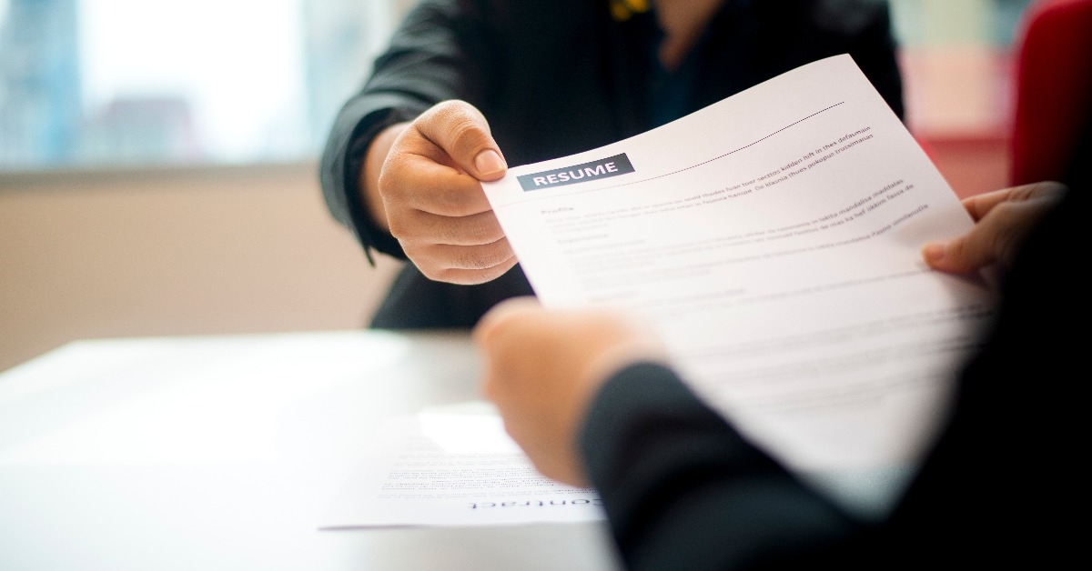 Hand giving the resume to the recruiter 