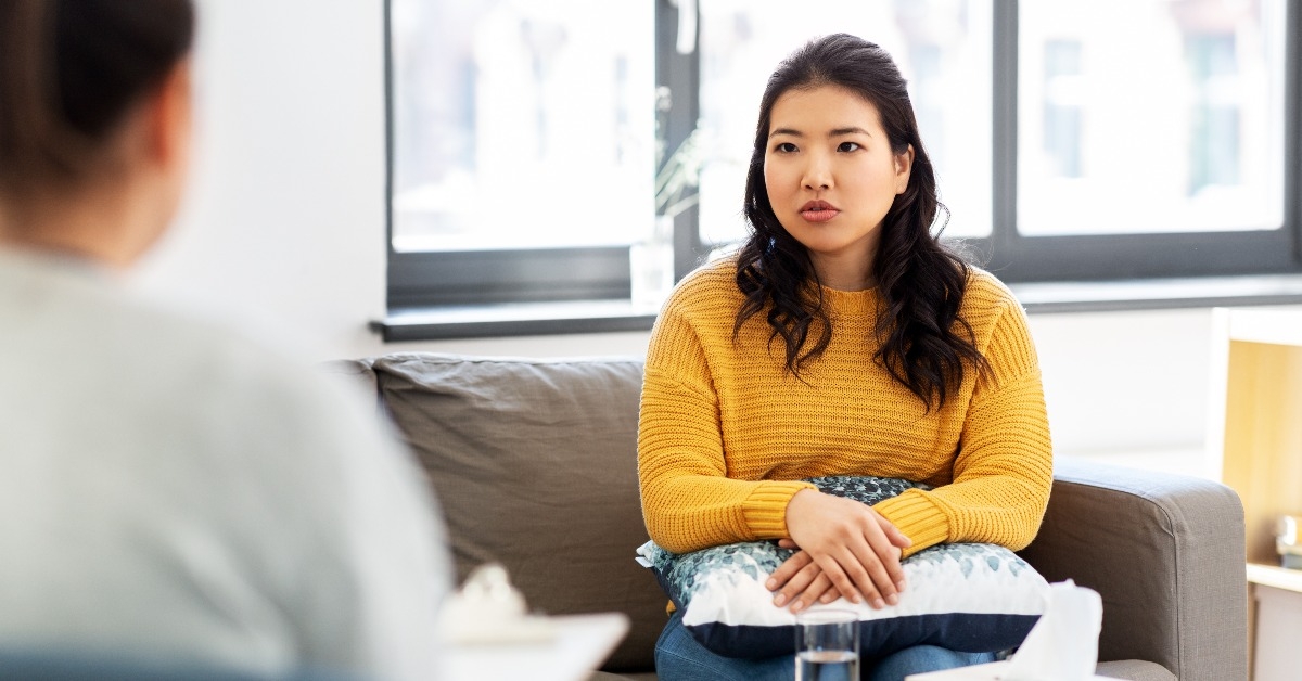 young asian woman patient and psychologist at psychotherapy session