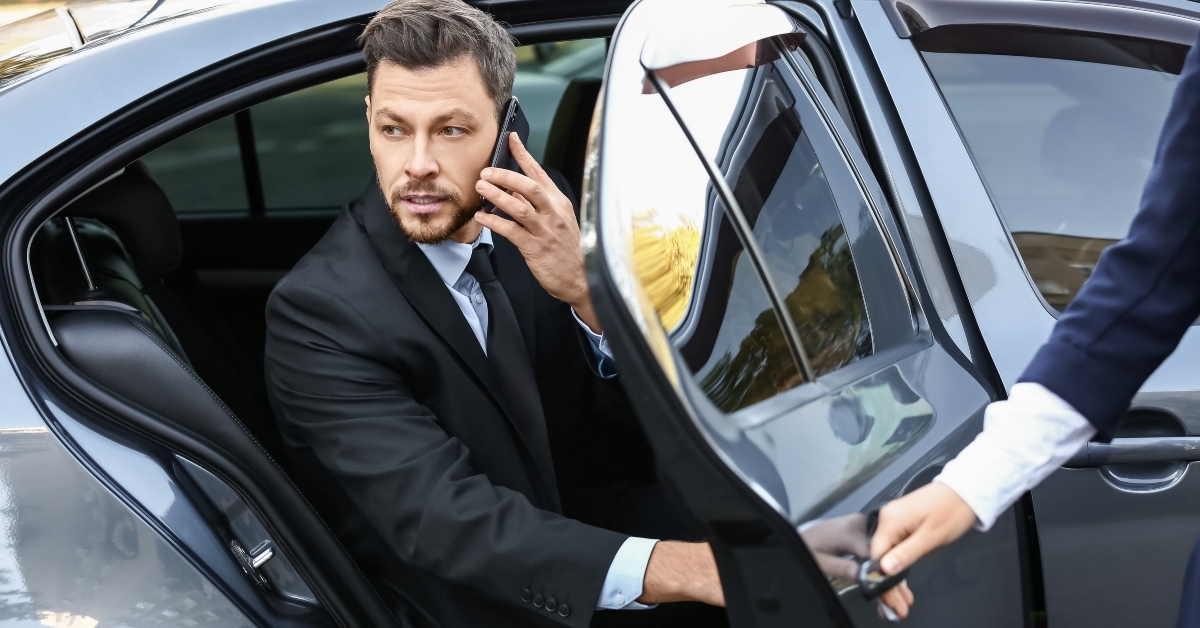 hotel valet opens a car door