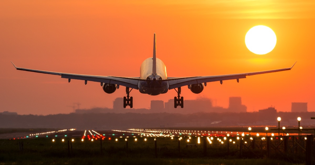 Passenger plane is landing during a wonderful sunrise