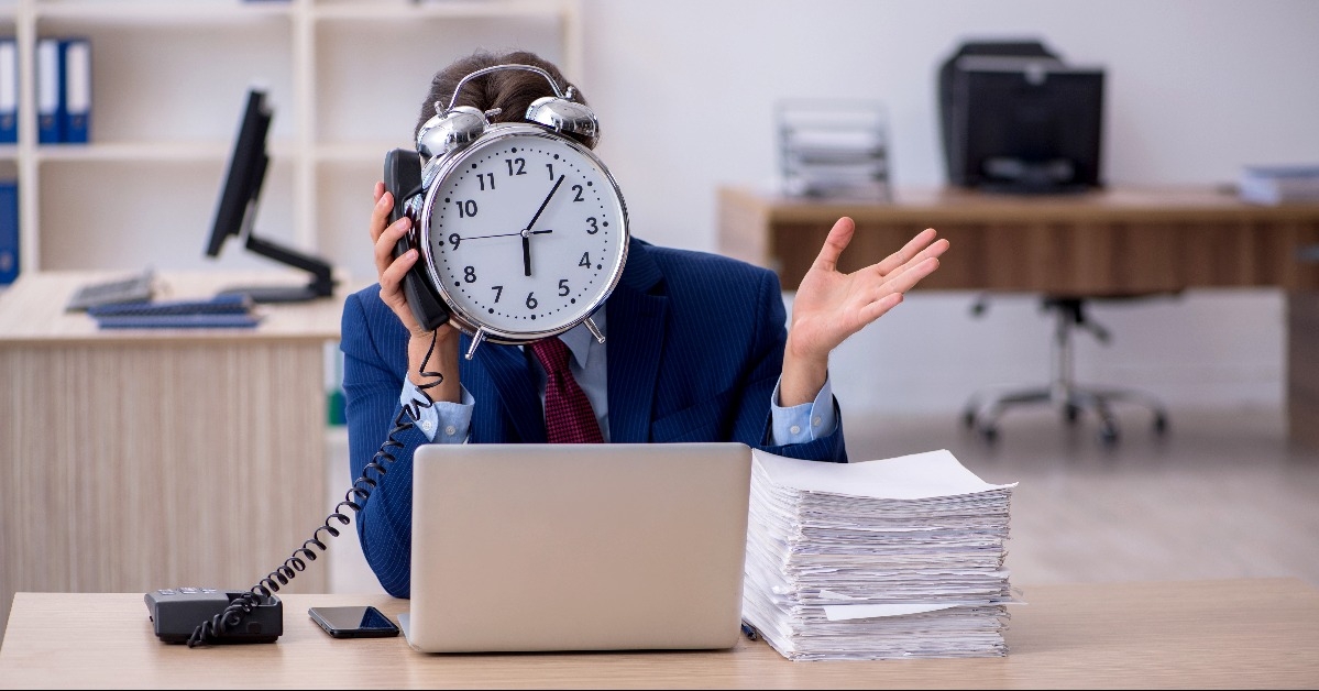 Young businessman employee and too much work in the office