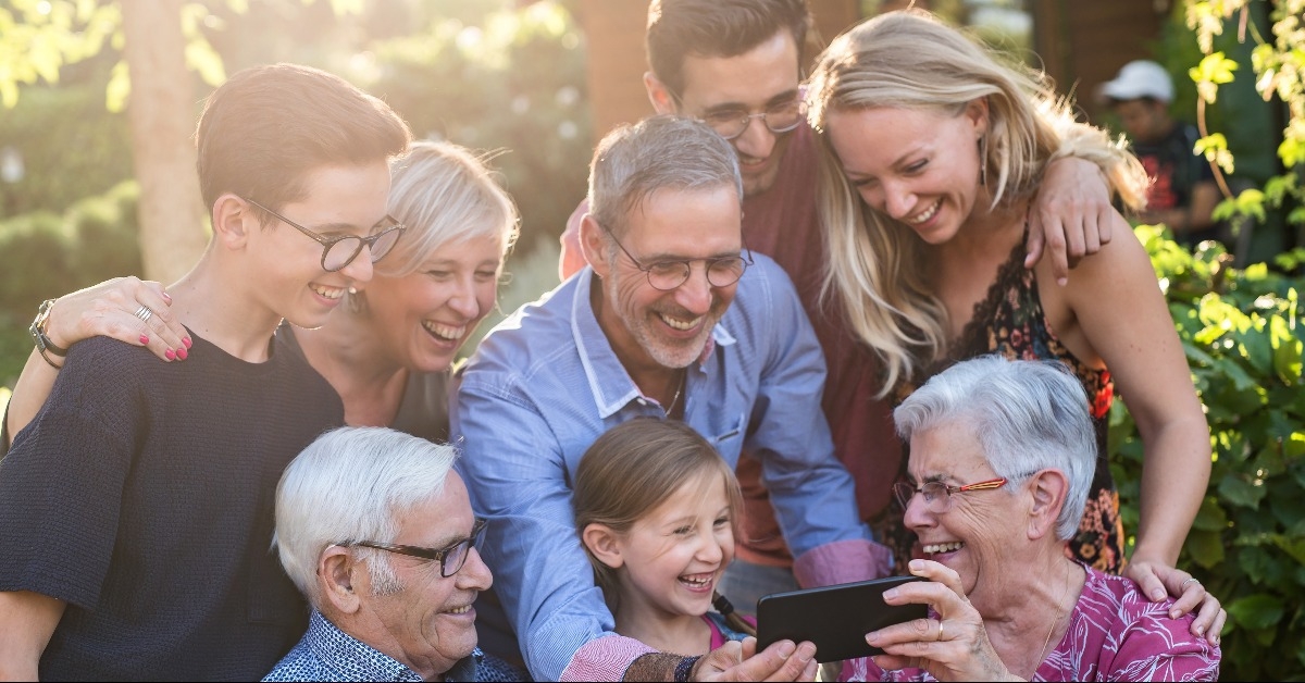  family have fun sharing a video on a phone