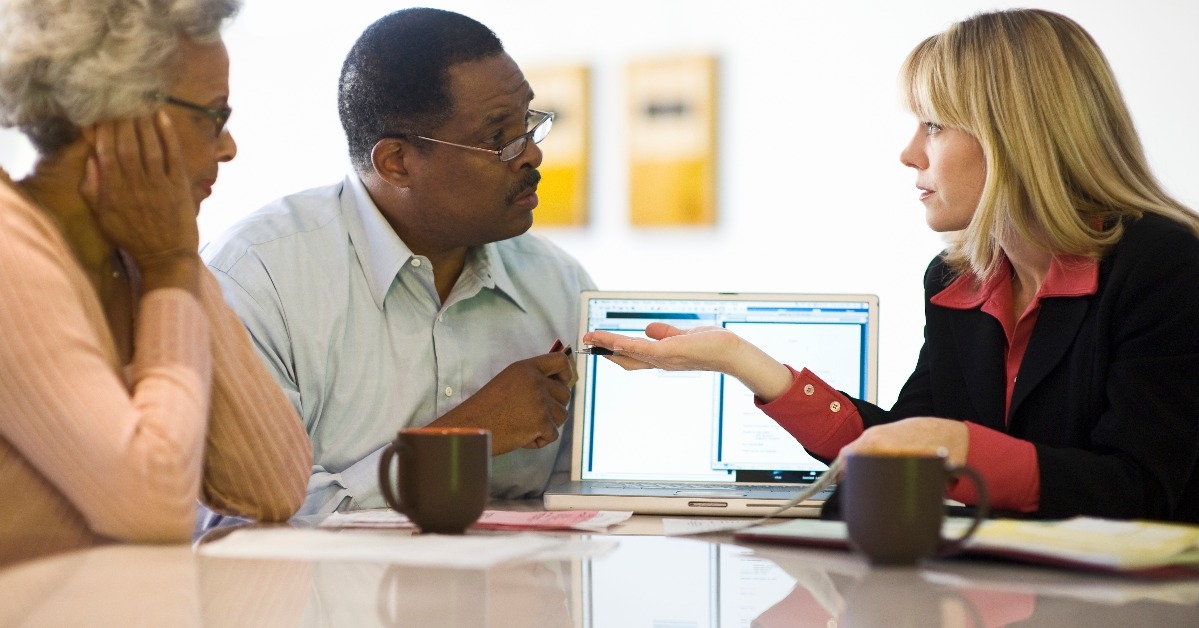 Financial advisor assisting an African American couple