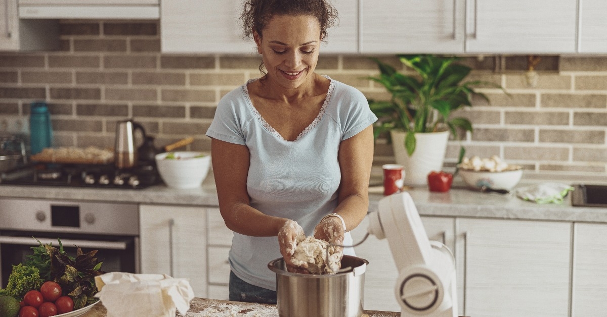 process of kneading pizza dough at home using a dough mixer