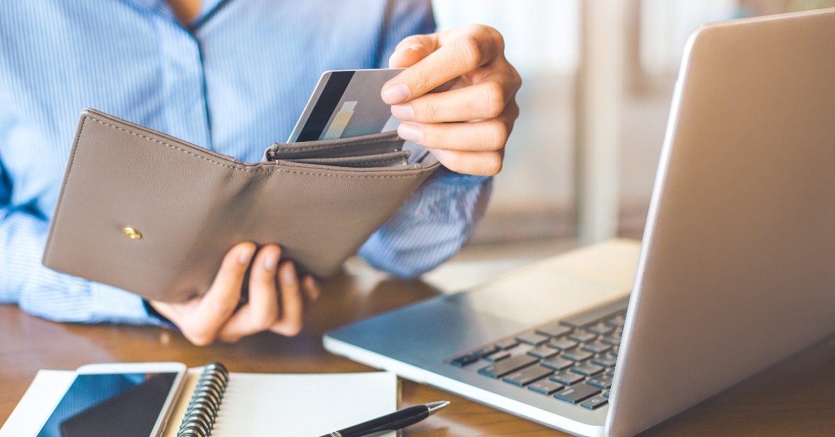 woman pulling a credit card from her wallet