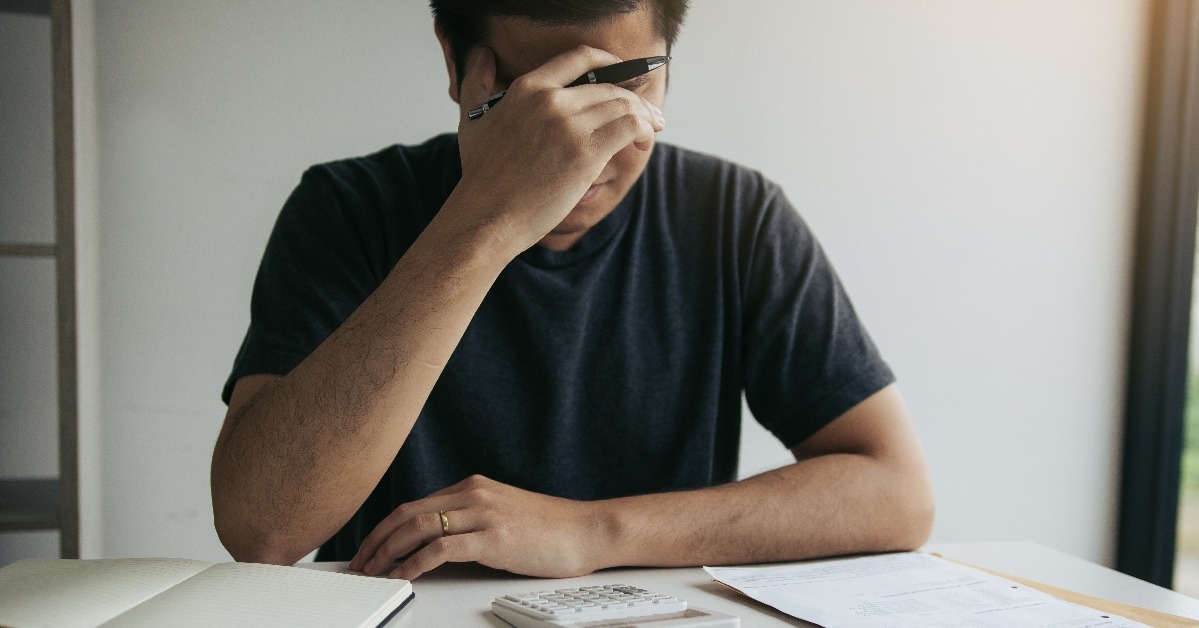 asian man stressed about financial problems