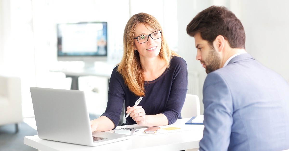 Business team working together on laptop at office