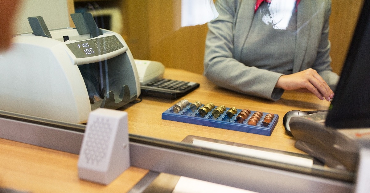 clerk counting cash money at bank office