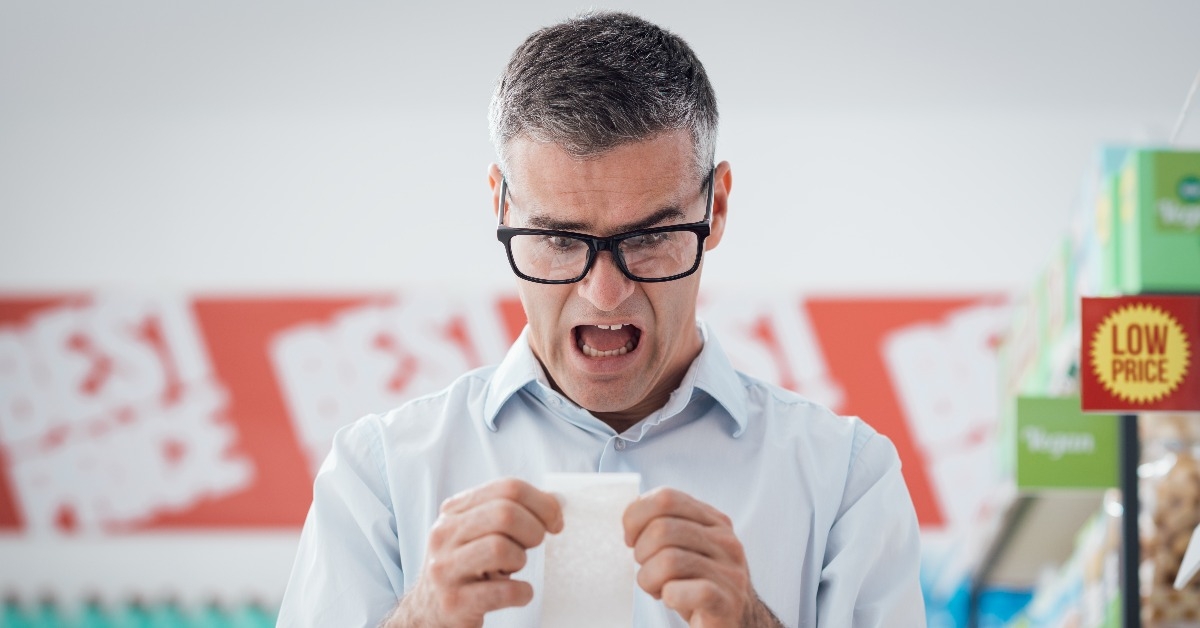 Man checking a long receipt