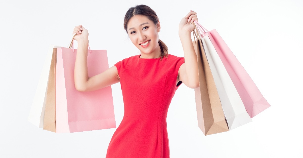 Shopping gift bags held by beautiful sexy young woman