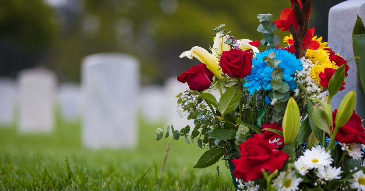 white grave markers and flowers at a national cemetary