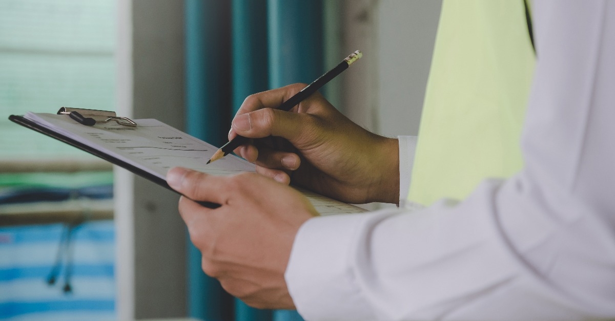 inspector checking and inspecting with clipboard