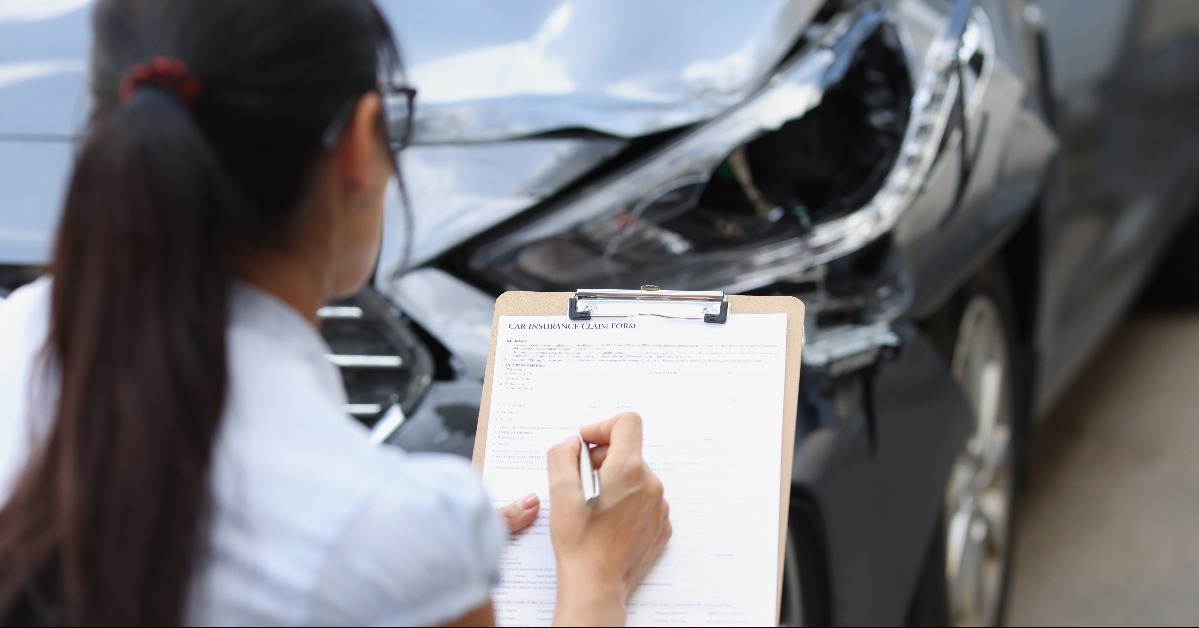 Woman agent filling out insurance claim form