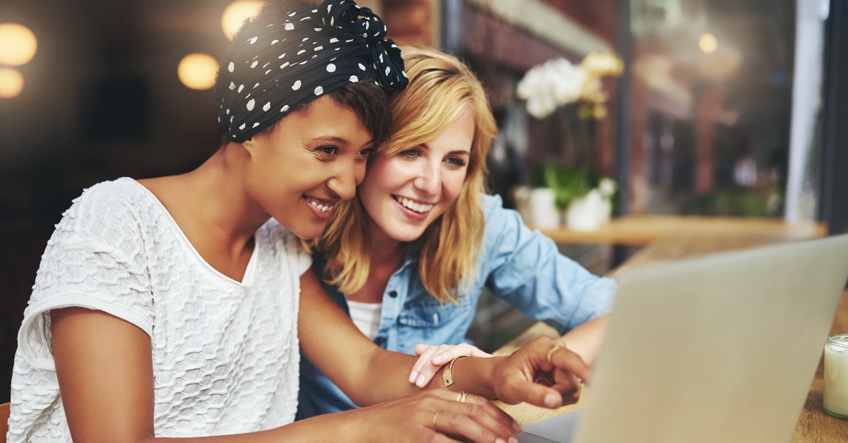 Two young female friends surfing the internet