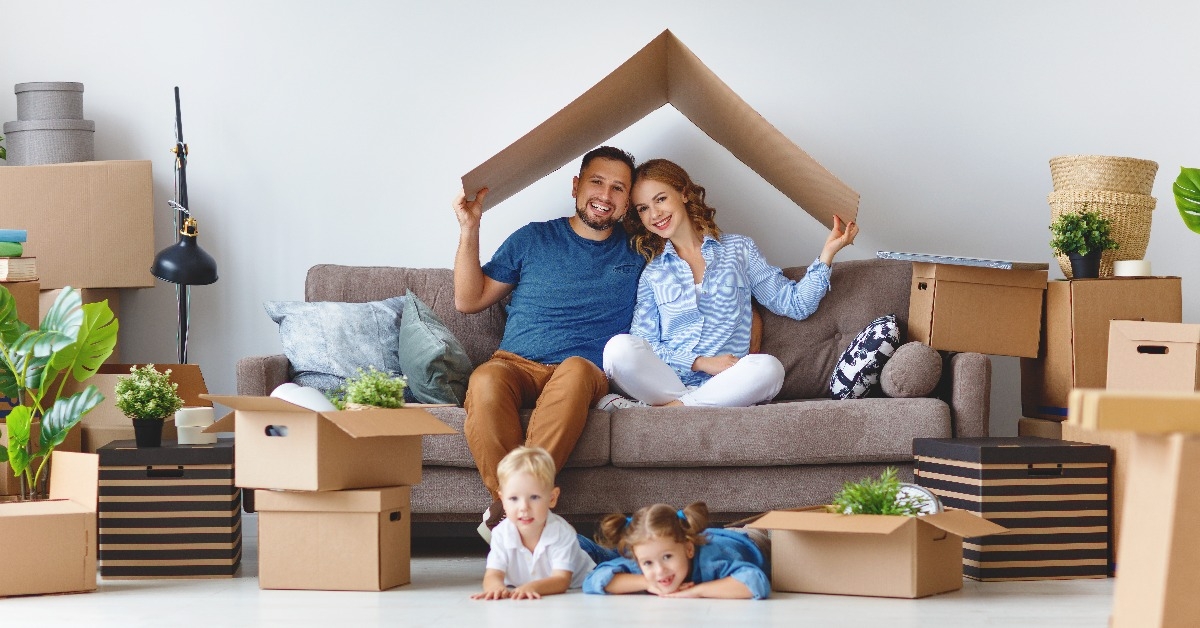happy family mother father and children move to new apartment