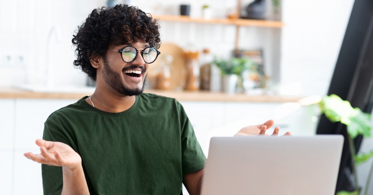  young male chatting online using laptop
