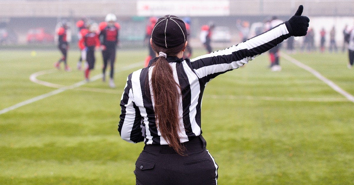 rear view of female american football referee