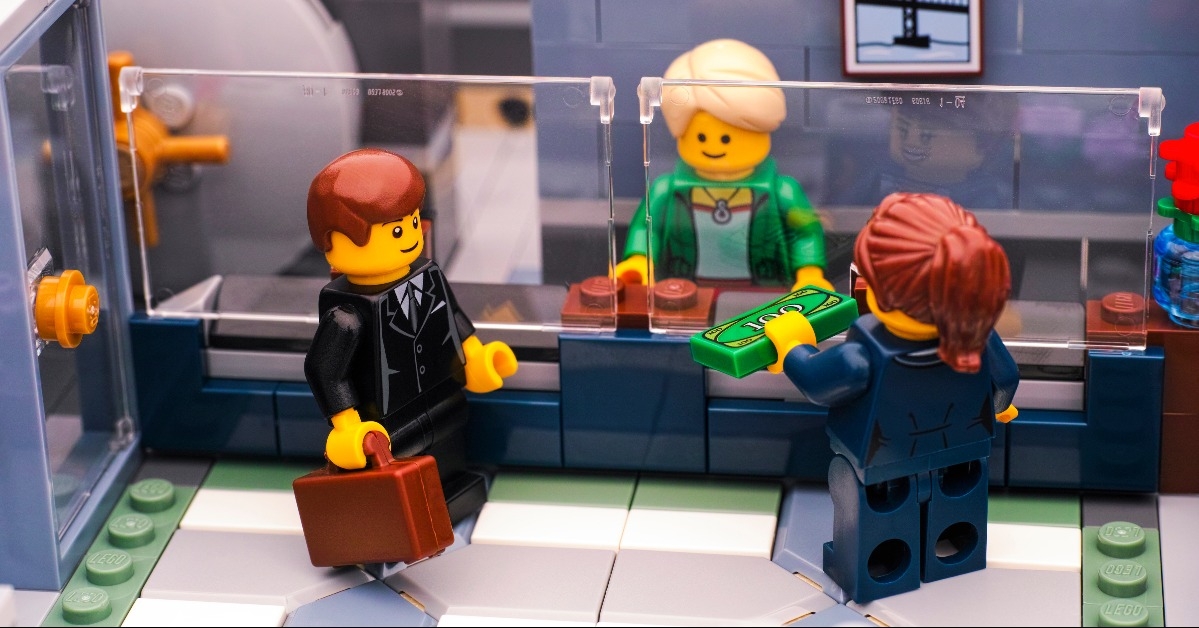 Lego businesswoman make deposit at respected Brick Bank