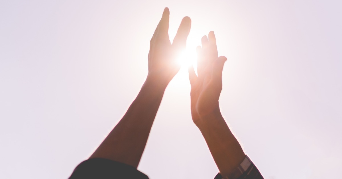 two friends beat high five outdoors on a summer day