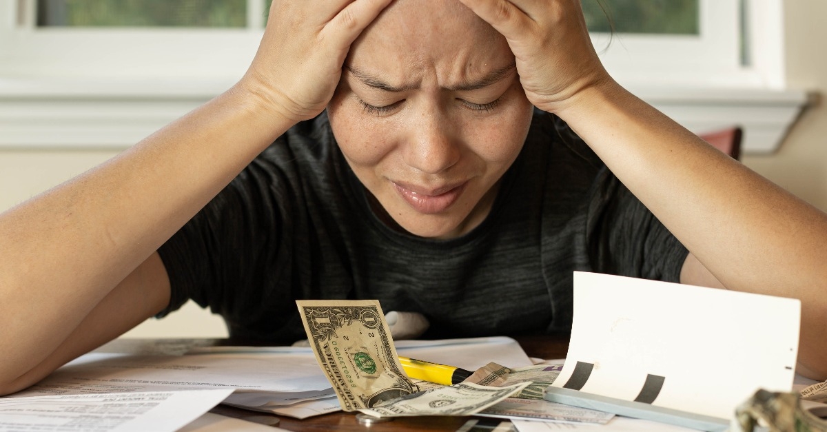 woman looking at her financial bills stressed out