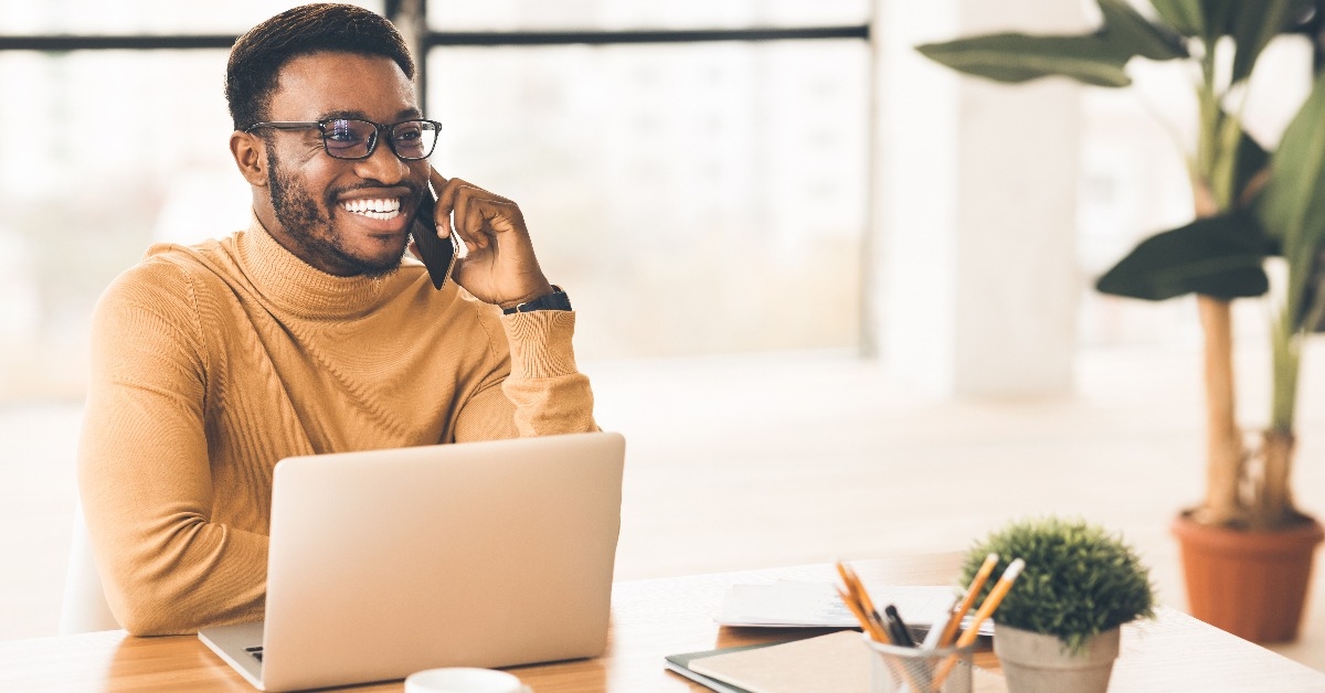 Black businessman talking on cell phone at office