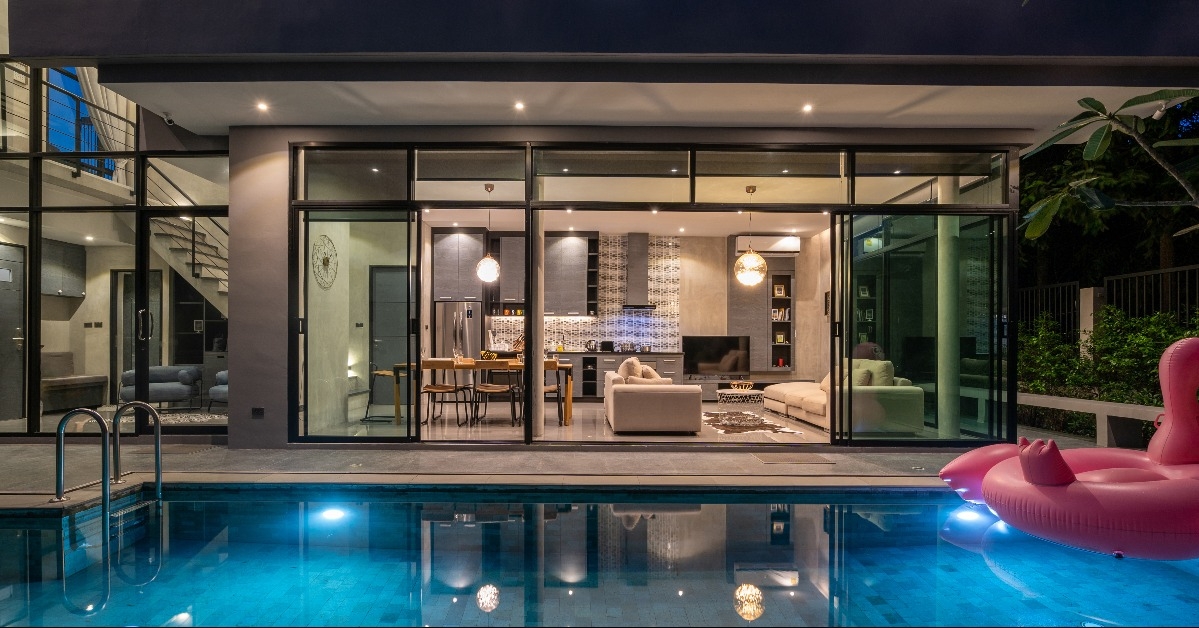 night exterior home with swimming pool in the house