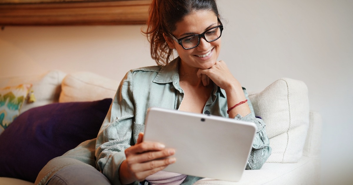  woman on couch at home with tablet