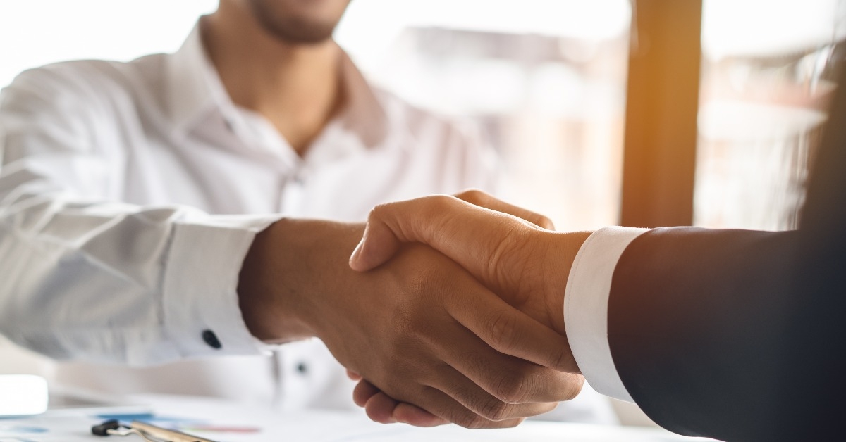 banker and client shaking hands after business loan grant