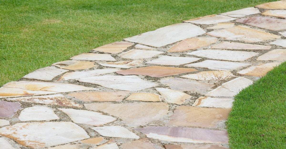 Stone pathway and green grass at green park