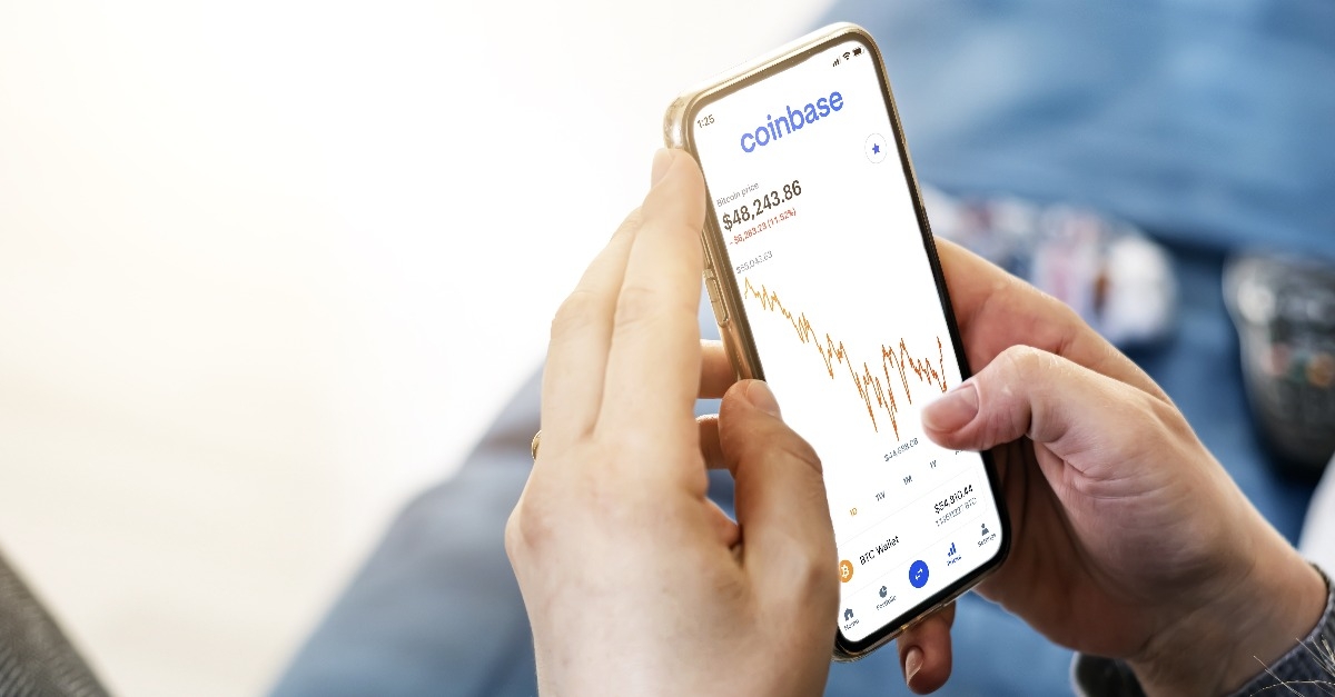 woman checking cryptocurrency quotes on her smart phone using the Coinbase app
