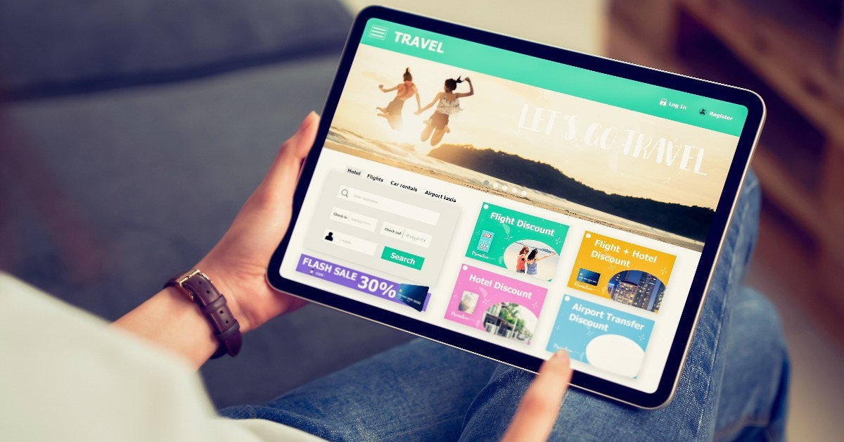 Hands holding digital tablet with application booking flight travel