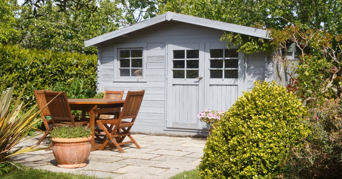shed with terrace and wooden garden furniture