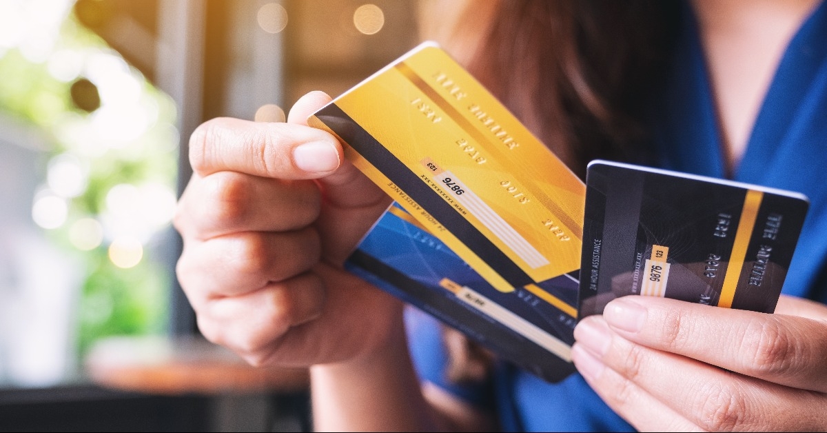 woman holding and choosing credit card to use