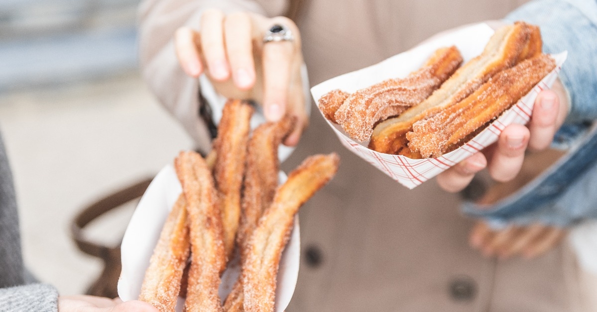 woman holding churros street food