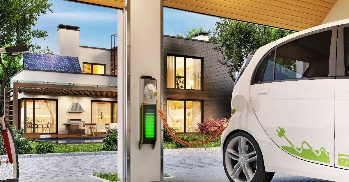 charging an electric car in the garage near the house