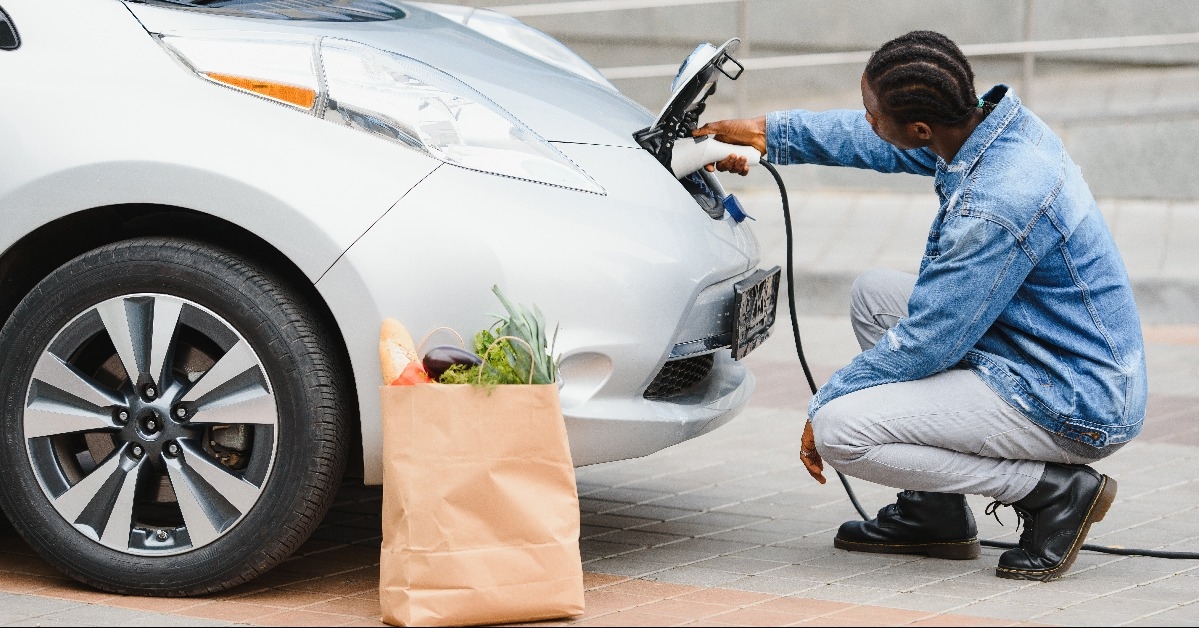 man charging his electric car