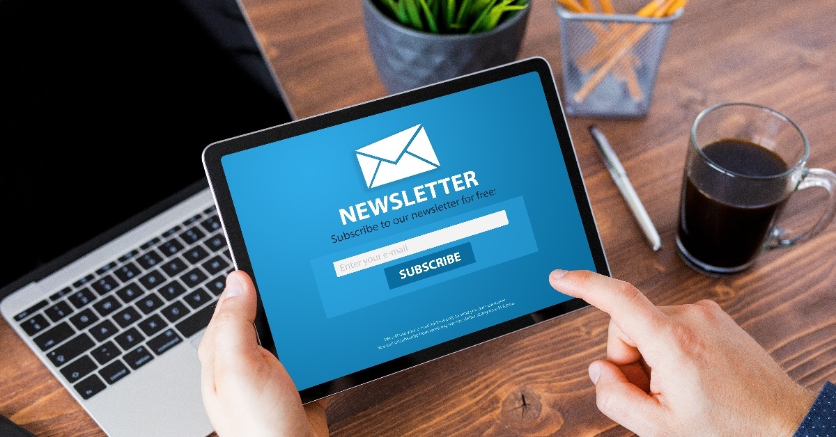 man viewing newsletter signup page on tablet computer