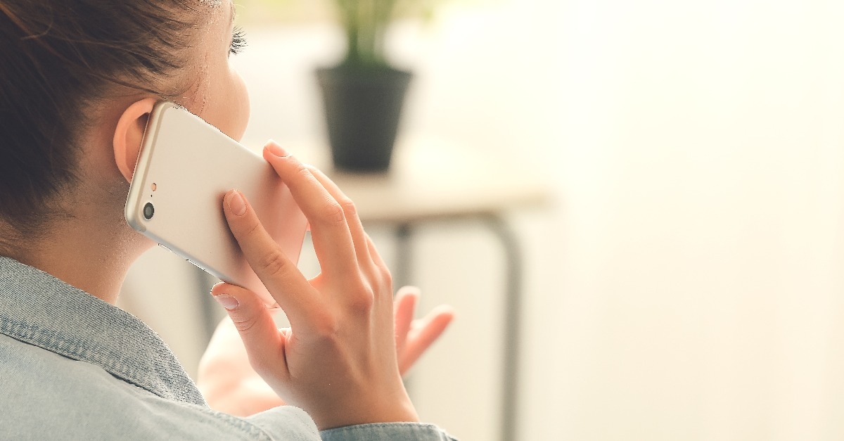 woman talking by mobile phone at home