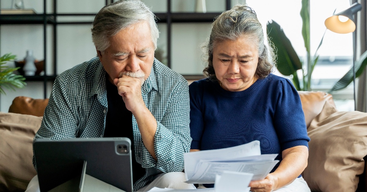 asian senior couple checking and calculate financial billing together